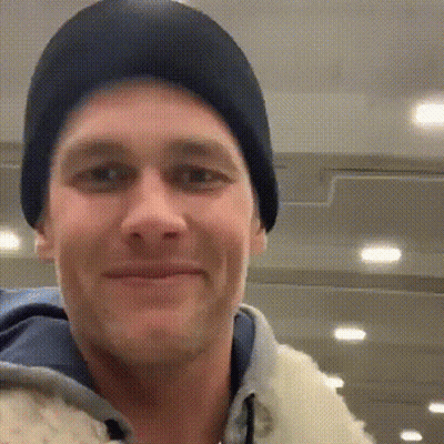 A Close Up Of A Man Wearing A Black Hat And A White Jacket . GIF