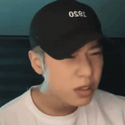 A Close Up Of A Man Wearing A Black Hat And A White Shirt . GIF