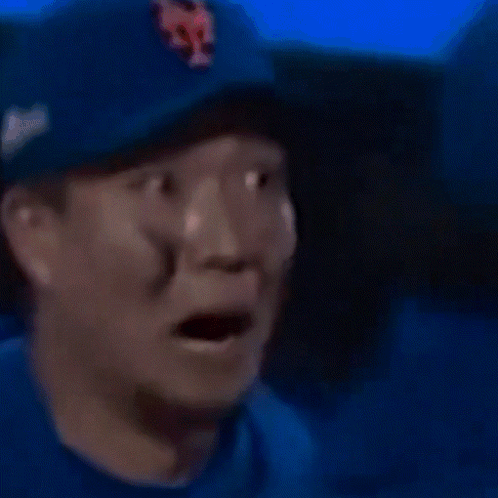 A Close Up Of A Man Wearing A Blue Hat With A Ny On It GIF