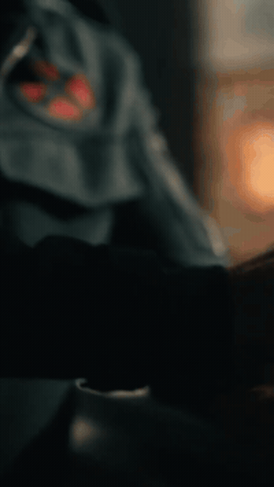 A Close Up Of A Man Wearing A Blue Jacket With A Red Cross On It GIF