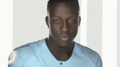 A Close Up Of A Man Wearing A Blue Shirt . GIF