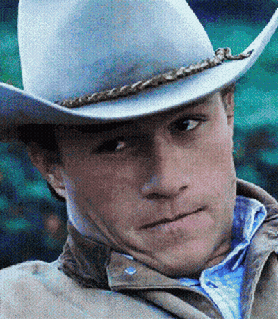 A Close Up Of A Man Wearing A Cowboy Hat And Jacket GIF