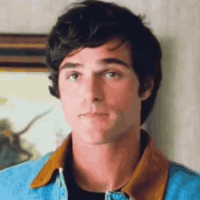 A Close Up Of A Man Wearing A Denim Jacket GIF