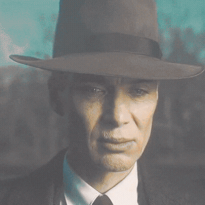 A Close Up Of A Man Wearing A Fedora And Tie GIF
