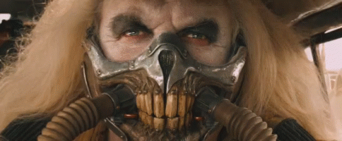 A Close Up Of A Man Wearing A Gas Mask With A Skull On It . GIF
