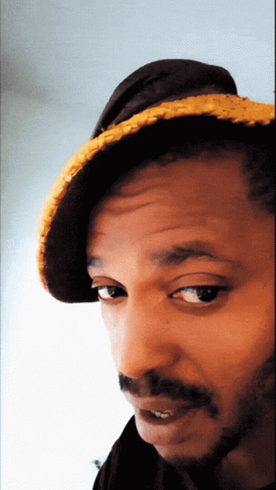 A Close Up Of A Man Wearing A Hat And A Beard GIF