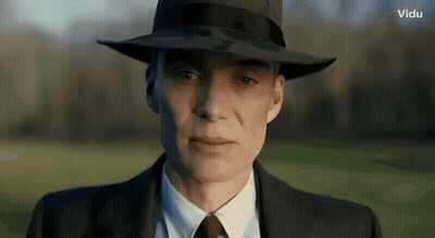 A Close Up Of A Man Wearing A Hat And A Suit GIF