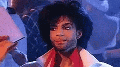 A Close Up Of A Man Wearing A Hat And A White Jacket . GIF