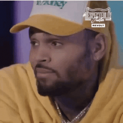 A Close Up Of A Man Wearing A Hat And A Yellow Hoodie . GIF