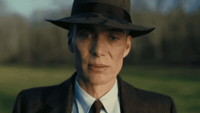 A Close Up Of A Man Wearing A Hat And Suit GIF