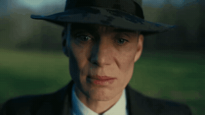 A Close Up Of A Man Wearing A Hat And Suit GIF