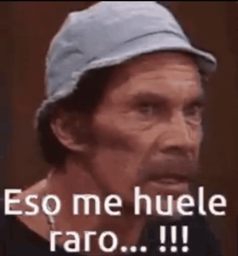 A Close Up Of A Man Wearing A Hat With The Words Eso Me Huele Raro Written On It . GIF