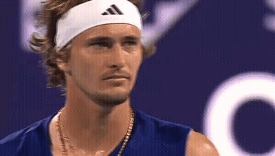 A Close Up Of A Man Wearing A Headband And A Necklace . GIF
