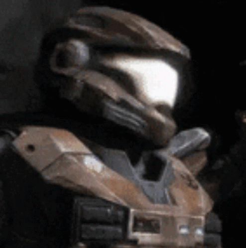 A Close Up Of A Man Wearing A Helmet And A Black Vest GIF