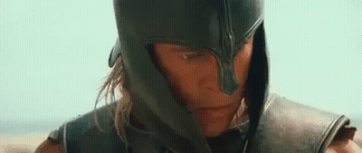 A Close Up Of A Man Wearing A Helmet And Armor Looking At The Camera . GIF