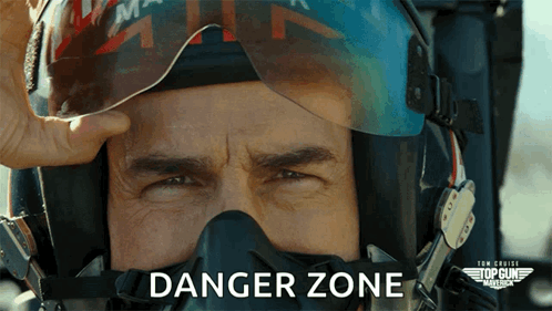A Close Up Of A Man Wearing A Helmet And Mask With The Words Danger Zone Above Him GIF