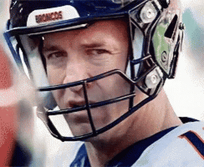 A Close Up Of A Man Wearing A Helmet With The Word Broncos On It GIF