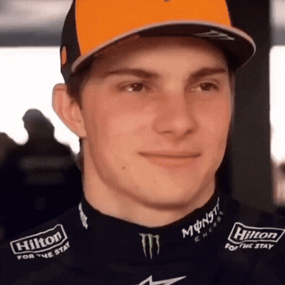 A Close Up Of A Man Wearing A Hilton For The Stay Shirt GIF