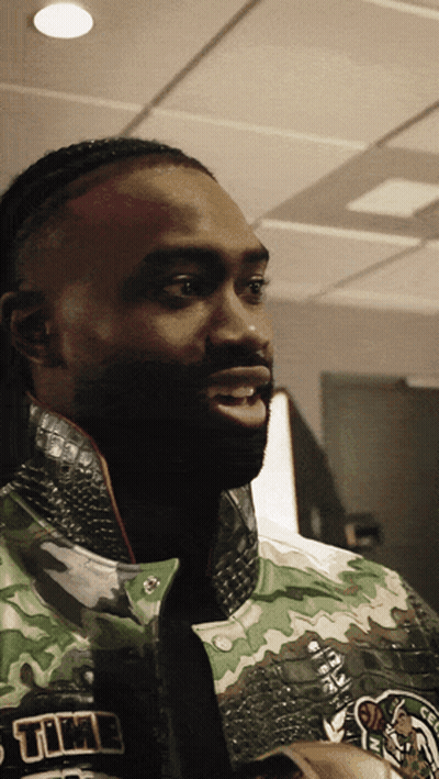 A Close Up Of A Man Wearing A Jacket That Says Celtics GIF