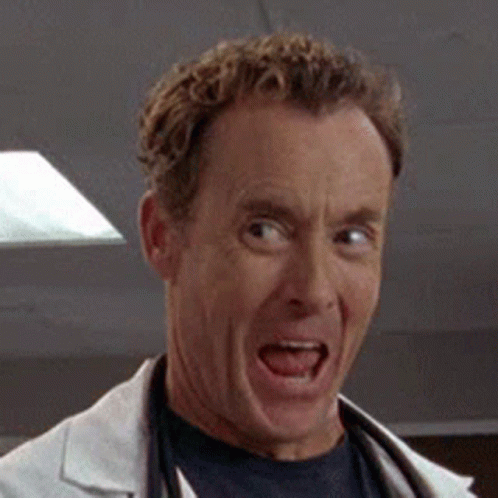 A Close Up Of A Man Wearing A Lab Coat And A Stethoscope Smiling . GIF