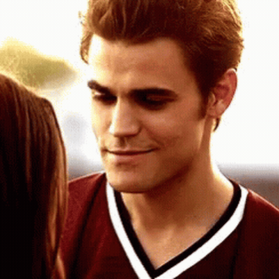 A Close Up Of A Man Wearing A Maroon Shirt With White Stripes GIF