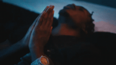 A Close Up Of A Man Wearing A Necklace And A Cross GIF