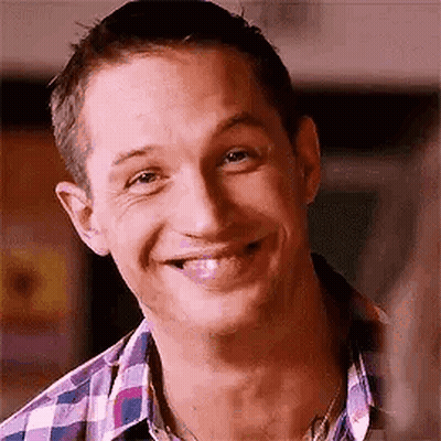 A Close Up Of A Man Wearing A Plaid Shirt And Smiling . GIF
