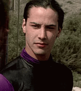 A Close Up Of A Man Wearing A Purple Shirt And A Black Jacket . GIF