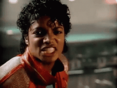 A Close Up Of A Man Wearing A Red Jacket And A Scarf Making A Funny Face . GIF