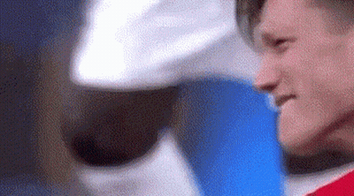 A Close Up Of A Man Wearing A Red Shirt And A White Hat . GIF