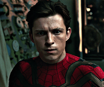 A Close Up Of A Man Wearing A Spiderman Costume GIF