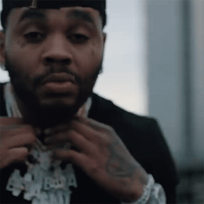 A Close Up Of A Man Wearing A Suit And A Hat . GIF