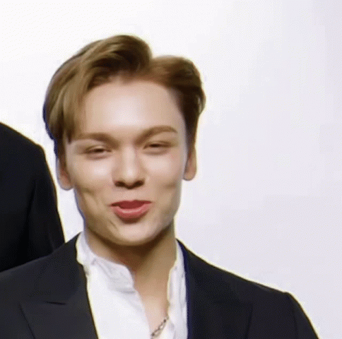 A Close Up Of A Man Wearing A Suit And A White Shirt Making A Funny Face . GIF