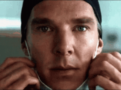 A Close Up Of A Man Wearing A Surgical Mask . GIF