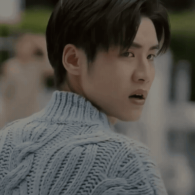 A Close Up Of A Man Wearing A Sweater With His Mouth Open GIF