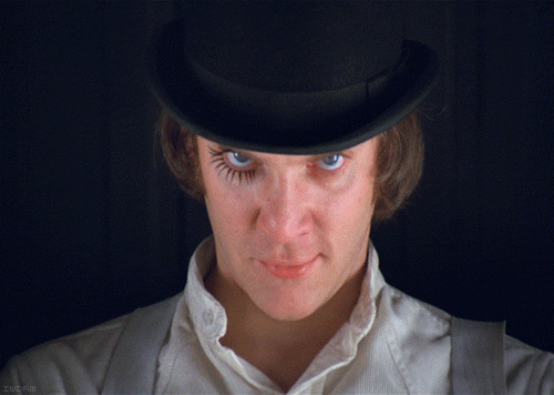 A Close Up Of A Man Wearing A Top Hat And A White Shirt GIF
