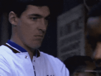 A Close Up Of A Man Wearing A White Jacket With A Blue Collar That Says Yale GIF