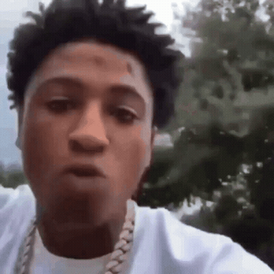 A Close Up Of A Man Wearing A White Shirt And A Gold Chain . GIF