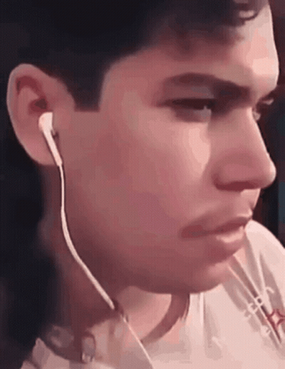 A Close Up Of A Man Wearing Ear Buds GIF