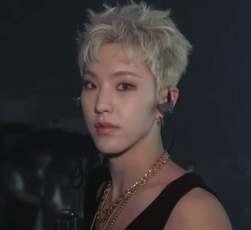 A Close Up Of A Man Wearing Earphones And A Gold Necklace GIF