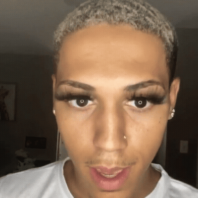 A Close Up Of A Man Wearing False Eyelashes GIF