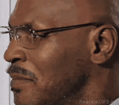 A Close Up Of A Man Wearing Glasses And A Beard . GIF