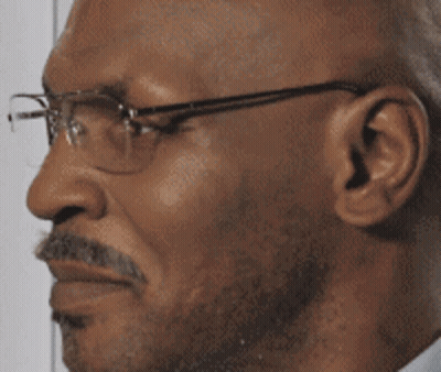 A Close Up Of A Man Wearing Glasses And A Beard GIF