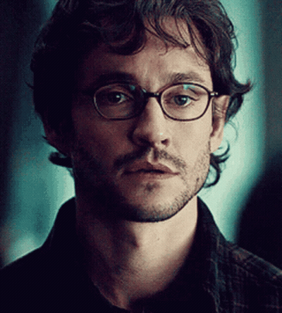 A Close Up Of A Man Wearing Glasses And A Beard GIF