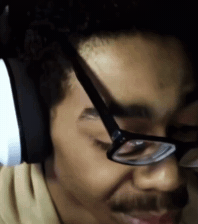 A Close Up Of A Man Wearing Glasses And A Headset GIF
