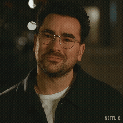 A Close Up Of A Man Wearing Glasses And A Netflix Logo GIF