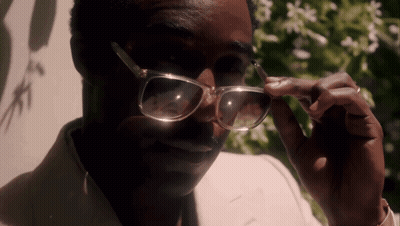A Close Up Of A Man Wearing Glasses And A Ring GIF