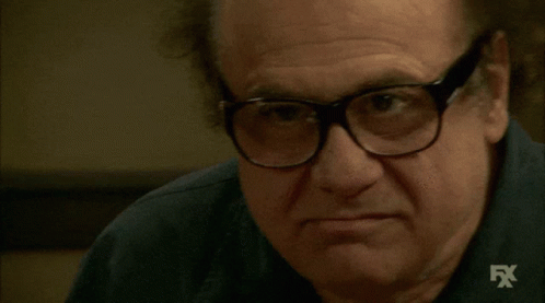 A Close Up Of A Man Wearing Glasses And A Shirt With Fx Written On It GIF
