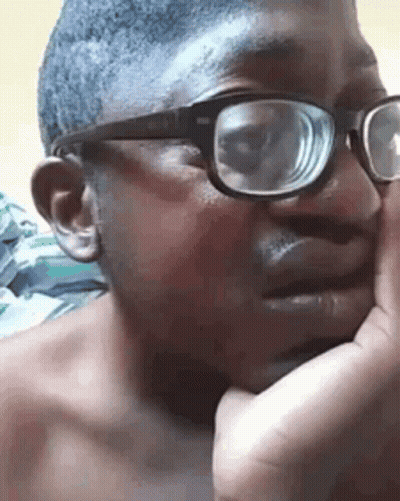 A Close Up Of A Man Wearing Glasses And A Shirtless Face . GIF