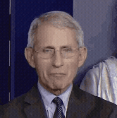 A Close Up Of A Man Wearing Glasses And A Suit . GIF